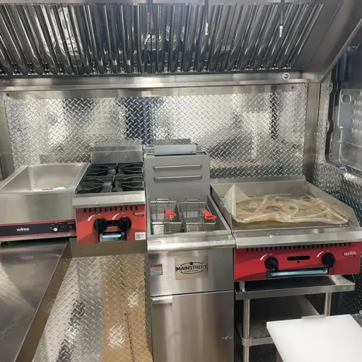 A food truck, complete with a stove and oven, is available for sale.